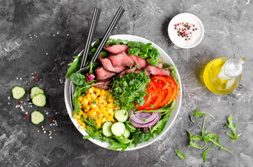 Fototapeta na wymiar Beef steak and Fresh Vegetables Buddha Bowl, Healthy Balanced Meal on Dark Background