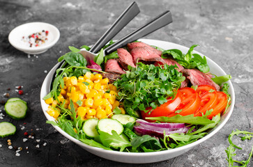 Beef steak and Fresh Vegetables Buddha Bowl, Healthy Balanced Meal on Dark Background