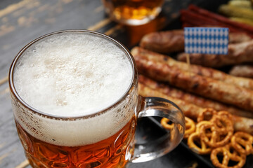 Mug of cold beer on dark wooden background. Oktoberfest celebration