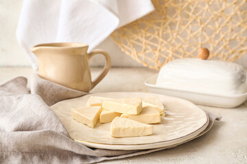 Plate with triangles of tasty processed cheese on light background, closeup