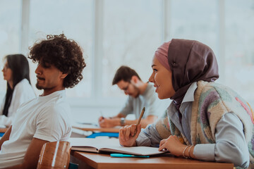 A group of diverse students engages in lively discussion as they educate themselves in a modern classroom, embracing the power of collaboration and knowledge exchange.