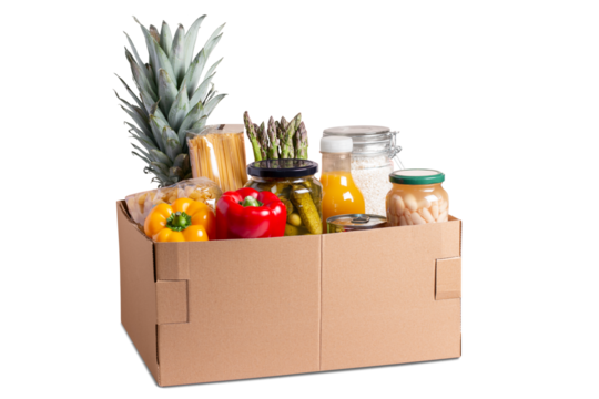 Isolated box with food for donation, charity concept. Canned food, pasta, fruits and vegetables in a box for donation isolated. - Powered by Adobe