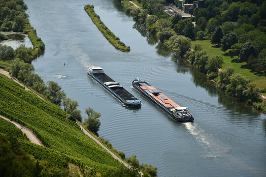 Bird's eye view of two barges on the Moselle loop surrounded by greenery and vineyards in Germany