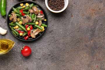 Plate with different vegetables on grunge background