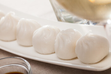 Dish of Asian cuisine - dim sum dumplings served on white plate