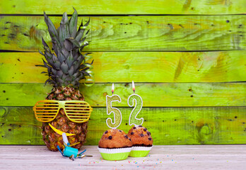 Creative card postcard happy birthday with number  52. Background character pineapple in festive...