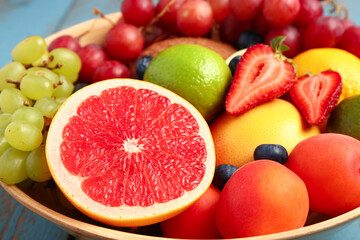 Bowl with different fresh fruits, closeup