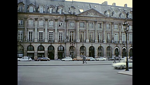 PARIS, FRANCE - CIRCA 1976: Touristic bus in Opera district at The Opera Garnier, the National Academy of Music. Today the angel statues are in golden color. Historic restored footage from Paris.