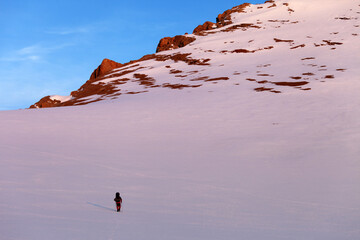 Hiker in sunrise snowy mountains. Turkey, Central Taurus Mountains, Aladaglar (Anti-Taurus).
