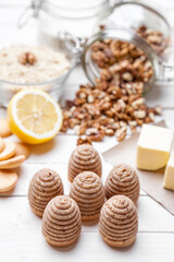 Traditional bee nest cake and ingredients on wooden background