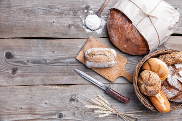 Delicious freshly baked bread on wooden background