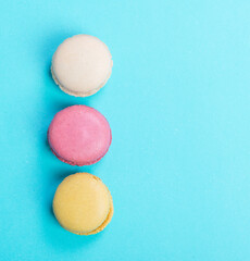 Colorful and tasty  French Macarons on blue background.Top view.
