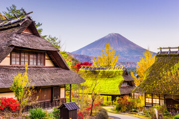 Mt. Fuji, Japan with historic village Iyashi no Sato during an autumn twilight.