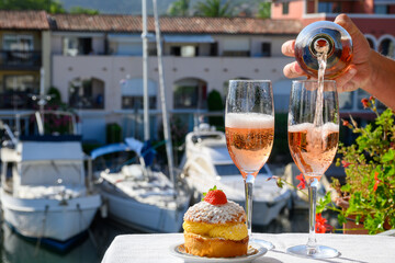 Summer party, drinking of French brut rose champagne sparkling wine in glasses in yacht harbour of Port Grimaud near Saint-Tropez, French Riviera vacation, France