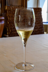 Tasting of grand cru sparkling white wine with bubbles champagne by old champagne house in grand cru wine producer small village Ambonnay, Champagne, France