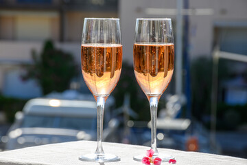 Summer party, drinking of French brut rose champagne sparkling wine in glasses in yacht harbour of Port Grimaud near Saint-Tropez, French Riviera vacation, France