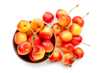Bowl with sweet yellow cherries on white background