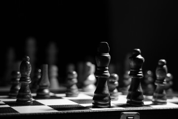 Game board with chess pieces on dark background, closeup