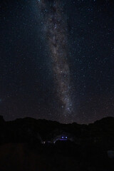 Fototapeta na wymiar The Milky Way Galaxy moving over the mountain ridge. Night lapse from night to day. Starry night.