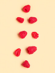 Fresh raspberries on yellow background