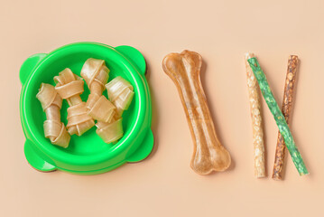 Set of different dog treats on color background