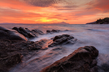 Fototapeta na wymiar Vourvourou - Karidi beach with mount Athos in the background surprised at sunrise.