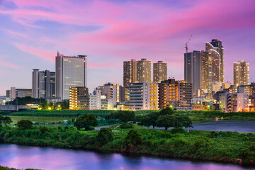 Fototapeta na wymiar Kawasaki, Japan skyline on the Tamagawa River.