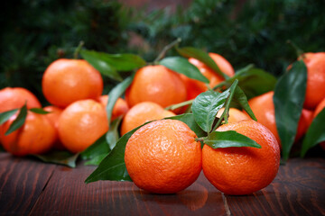 Fototapeta na wymiar Tangerines with leaves on wooden surface. Citrus fruit