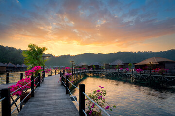 Overwater bungalow at dusk.Beautiful sunset over beach with water villas.Summer vacation concept