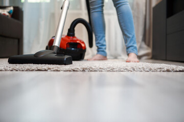 Woman with vacuum cleaner after cleaning. Home hygiene