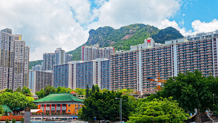 hong kong public estate with landmark lion rock at day