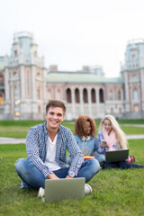 Young man with laptop outdoors