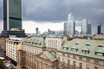 Fototapeta na wymiar Old residences and modern office buildings at Warsaw city center. Cloudy Day.