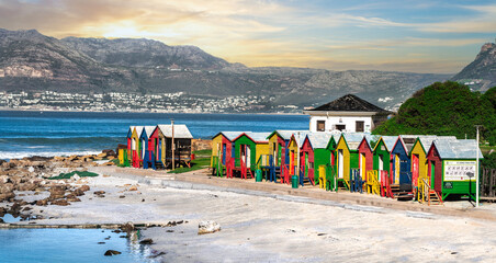 Obraz premium Rainbow Hues by the Sea: Captivating Change Rooms at Muizenberg Beach, Cape Town - Colourful Coastal Retreat, Iconic Beach scape, Quirky Seaside Vibes