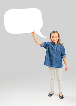 Beautiful little girl holding and showing a speech balloon