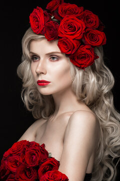 Beautiful blond girl in a dress and hat with roses, classic makeup, curls and red lips. Beauty face. Photos shot in studio
