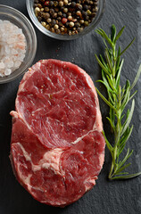 Fresh raw steak with salt and pepper