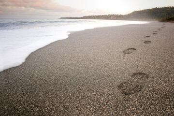 footsteps path on a Caribbean beach in Cuba during the sunset 