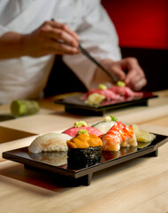 Assorted Sushi with Chef as background © Designpics