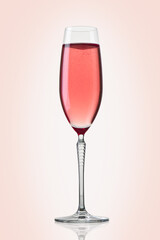 Glass of pink champagne on pink background