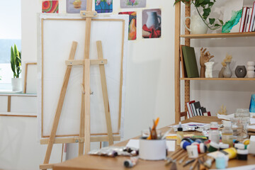 Wooden easel with canvas in artist's studio. Creative hobby