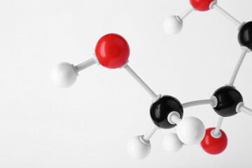Molecule of glucose on light grey background, closeup. Chemical model