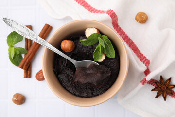 Tasty chocolate mug pie on white tiled table, flat lay. Microwave cake recipe