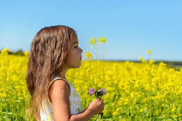 Fototapeta premium Portrait of a girl in rapeseed field (Green Gables Shore, Prince Edward Island , Canada)