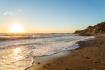 Ocean shore at sunset (Cabot Trail, Cape Breton, Nova Scotia, Canada)