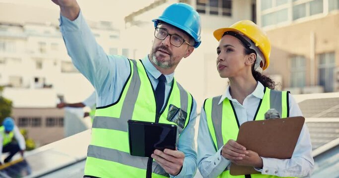 Teamwork, leader or engineers with tablet on construction site for planning, pointing or building a project. Industrial, boss or senior contractor engineering or speaking to contractor for inspection