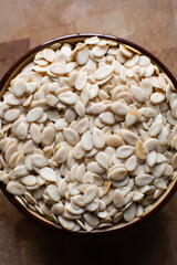 nigerian egusi seeds in a brown bowl, shelled melon seeds in a bowl, nigerian melon seeds, pumpkin seeds for cooking