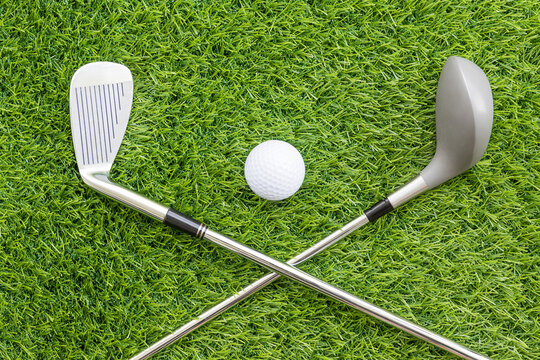 Sport objects related to golf equipment ,Golf club and ball on green grass