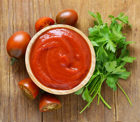 tomato sauce (ketchup) in a wooden bowl