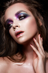 Beautiful young model with bright make-up and manicure